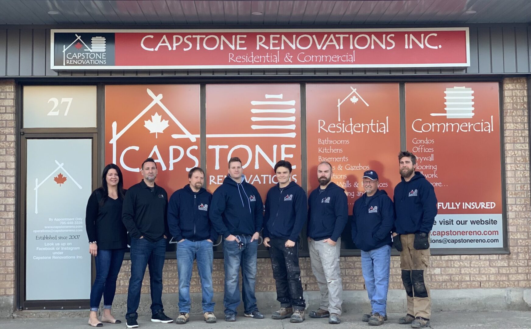 A group of people standing in front of a building.